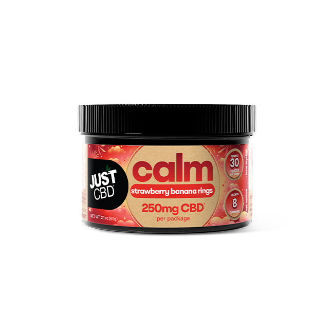 A black plastic jar of Just CBD 'calm' edible gummies, strawberry banana rings flavor, 250mg CBD per package, on a clean white background.
