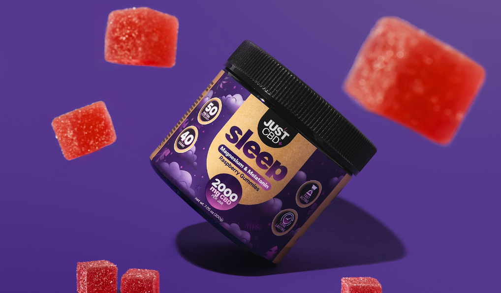 Jar of 'Just Sleep' gummies with red gummy bears on a purple background